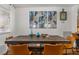 Dining room boasts a rustic table, seating for eight, and modern wall art at 5350 Topaz St, Las Vegas, NV 89120