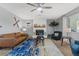 Bright living room features a ceiling fan, comfortable seating, and a modern fireplace design at 5350 Topaz St, Las Vegas, NV 89120