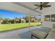 Covered patio with outdoor seating and view of the manicured lawn and landscaped backyard at 5350 Topaz St, Las Vegas, NV 89120