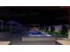 Nighttime view of the inviting pool and spa with ambient lighting and lounge area at 5350 Topaz St, Las Vegas, NV 89120