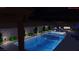 Stunning backyard pool with a built-in spa, outdoor kitchen, and lounge seating, lit for evening enjoyment at 5350 Topaz St, Las Vegas, NV 89120