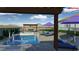 Luxurious backyard pool with a built-in spa, pergola, and lounge chairs at 5350 Topaz St, Las Vegas, NV 89120