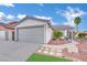 Charming single-story home with a well-manicured front yard and a two-car garage in a desirable neighborhood at 585 Jackson Dr, Henderson, NV 89014