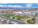 An aerial view of a neighborhood and local community baseball field with mountains in the background at 585 Jackson Dr, Henderson, NV 89014
