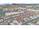 An aerial view of a neighborhood and local businesses with the mountains in the background at 585 Jackson Dr, Henderson, NV 89014