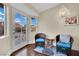 Bright sitting area with wicker chairs, a table, and natural light from a glass door at 585 Jackson Dr, Henderson, NV 89014