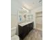 Well-lit bathroom with double sinks, granite countertop, and vanity providing ample storage at 6840 Sunflower Fields St, North Las Vegas, NV 89086