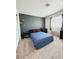 Comfortable bedroom with a blue comforter, neutral carpet, and natural light for a cozy atmosphere at 6840 Sunflower Fields St, North Las Vegas, NV 89086