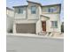 Modern two-story home featuring an attached garage, brick steps, and fresh landscaping at 6840 Sunflower Fields St, North Las Vegas, NV 89086