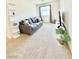 Comfortable living room offers plush seating, neutral carpeting, and plenty of natural light at 6840 Sunflower Fields St, North Las Vegas, NV 89086