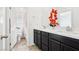Bathroom showcasing a dual sink vanity with modern fixtures and vanity with black cabinets at 6844 Bayou Hollow Ave, Las Vegas, NV 89156