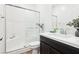 Modern bathroom features white subway tile, a shower with glass door, and a dark vanity at 6844 Bayou Hollow Ave, Las Vegas, NV 89156