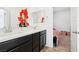 Bathroom featuring a double vanity, white countertops and dark cabinetry, and orange floral accents at 6844 Bayou Hollow Ave, Las Vegas, NV 89156