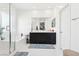 This bright and airy bathroom features a double sink vanity, tub and tiled floor at 6844 Bayou Hollow Ave, Las Vegas, NV 89156