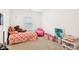 Bright bedroom featuring a window, a bed with colorful coverings, and decorations at 6844 Bayou Hollow Ave, Las Vegas, NV 89156