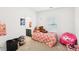 A bedroom with a rainbow coverlet, toys, and a bathroom just off of the bedroom at 6844 Bayou Hollow Ave, Las Vegas, NV 89156