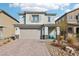 Charming two-story home featuring a brick driveway, desert landscaping, and a welcoming covered front porch at 6844 Bayou Hollow Ave, Las Vegas, NV 89156