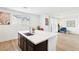 Modern kitchen featuring a center island with a quartz countertop, and open to the living room area at 6844 Bayou Hollow Ave, Las Vegas, NV 89156
