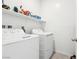 Laundry room with shelving and white washer and dryer at 6844 Bayou Hollow Ave, Las Vegas, NV 89156