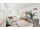 Bright living room with a comfortable sectional, stylish decor, and light wood flooring throughout at 6844 Bayou Hollow Ave, Las Vegas, NV 89156