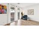 Cozy living room with hardwood flooring, sliding glass doors to backyard, and a comfortable arm chair at 6844 Bayou Hollow Ave, Las Vegas, NV 89156