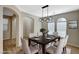 Dining room with modern light fixture, neutral walls, floors, and large windows at 7158 Clear Range Ave, Las Vegas, NV 89178