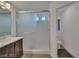 Bathroom featuring a single vanity with a white countertop and a glass enclosed shower with white tile surround at 8144 Monsoon Bay St, Las Vegas, NV 89113