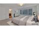 Bright bedroom with neutral tones, natural light, and modern furnishings with an ensuite bath at 8144 Monsoon Bay St, Las Vegas, NV 89113