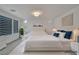 Bright bedroom featuring two beds, modern decor, and plenty of natural light at 8144 Monsoon Bay St, Las Vegas, NV 89113