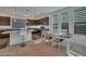 Well-lit kitchen featuring granite countertops, dark wood cabinets, and a breakfast bar for modern convenience at 8144 Monsoon Bay St, Las Vegas, NV 89113