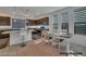 Well-lit kitchen features dark cabinetry, granite countertops, stainless appliances, and a breakfast nook at 8144 Monsoon Bay St, Las Vegas, NV 89113