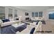 Bright and airy living room featuring plush sofas, stylish decor, and large windows for natural light at 8144 Monsoon Bay St, Las Vegas, NV 89113