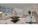 Inviting living room bathed in natural light with modern decor, comfortable seating, and an elegant staircase at 8144 Monsoon Bay St, Las Vegas, NV 89113