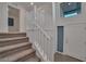 Inviting staircase features carpeted steps, white railings, and abundant natural light through a high window at 8144 Monsoon Bay St, Las Vegas, NV 89113
