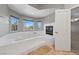 Bathroom includes a large soaking tub, a fireplace and multiple windows for natural light at 8904 Saint Pierre Dr, Las Vegas, NV 89134