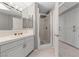 Neutral bathroom boasts a walk-in shower, a large white vanity, and built in storage at 8904 Saint Pierre Dr, Las Vegas, NV 89134
