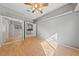 Bright bedroom featuring wood floors, mirrored closet doors, and ensuite access to bathroom at 8904 Saint Pierre Dr, Las Vegas, NV 89134