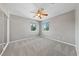 Spacious bedroom with carpet, ceiling fan, and two large windows at 8904 Saint Pierre Dr, Las Vegas, NV 89134