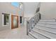 Spacious front foyer with elegant staircase, high ceilings, and decorative front door at 8904 Saint Pierre Dr, Las Vegas, NV 89134