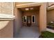 Inviting front entrance with a covered porch, decorative door, and well-maintained landscaping at 8904 Saint Pierre Dr, Las Vegas, NV 89134