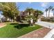 Charming two-story home with manicured lawn, mature trees, and a spacious driveway at 8904 Saint Pierre Dr, Las Vegas, NV 89134