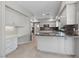 Elegant kitchen with marble countertops, stainless steel appliances, and stylish white cabinetry at 8904 Saint Pierre Dr, Las Vegas, NV 89134