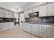 Modern kitchen design with stainless steel appliances, marble backsplash, and elegant white cabinets at 8904 Saint Pierre Dr, Las Vegas, NV 89134