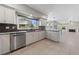 Open-concept kitchen featuring marble countertops, stainless steel dishwasher, and white cabinets overlooking the living room at 8904 Saint Pierre Dr, Las Vegas, NV 89134