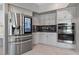 Updated kitchen with a large stainless steel refrigerator and double ovens complements the white cabinetry at 8904 Saint Pierre Dr, Las Vegas, NV 89134