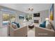 Bright living room with a fireplace, neutral decor, and sliding glass doors to the outdoor pool at 8904 Saint Pierre Dr, Las Vegas, NV 89134