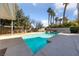 A beautiful pool with clear blue water and mature palm trees in the background at 8904 Saint Pierre Dr, Las Vegas, NV 89134