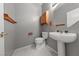 Cozy powder room with a pedestal sink, wood accents, and elegant fixtures at 8904 Saint Pierre Dr, Las Vegas, NV 89134