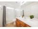 A full bathroom with a tub-shower, neutral tile floors, and a wood vanity at 9257 Harbor Stream Ave, Las Vegas, NV 89149