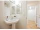 Bathroom featuring a pedestal sink and a view into an adjacent room at 9257 Harbor Stream Ave, Las Vegas, NV 89149